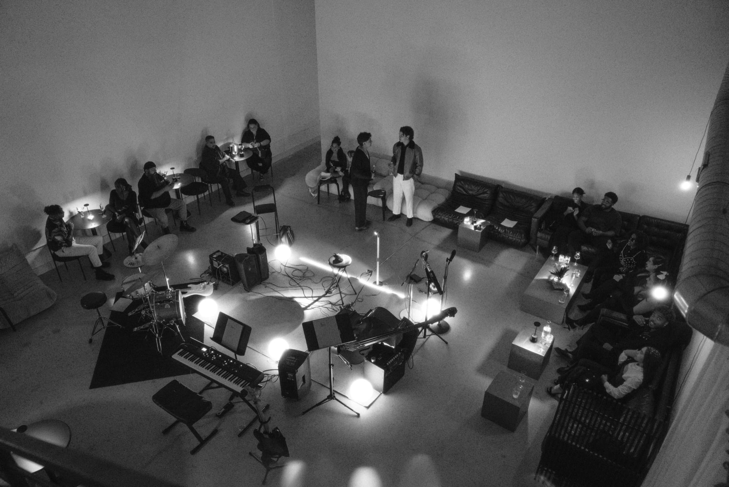 The Luxe Lounge from the mezzanine — the band playing in the round, guests seated on all four sides.